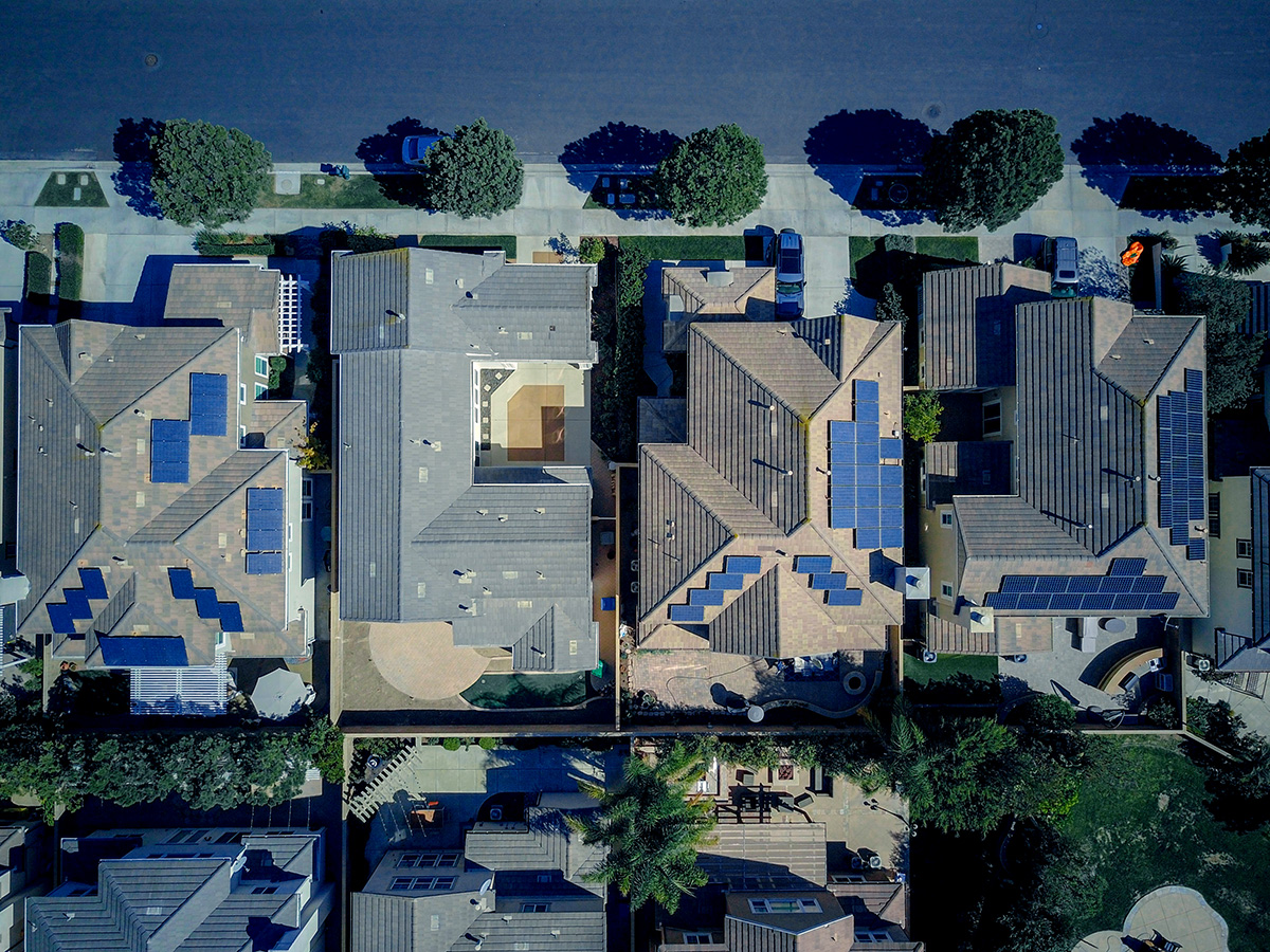 A top-down view of homes with solar panels.