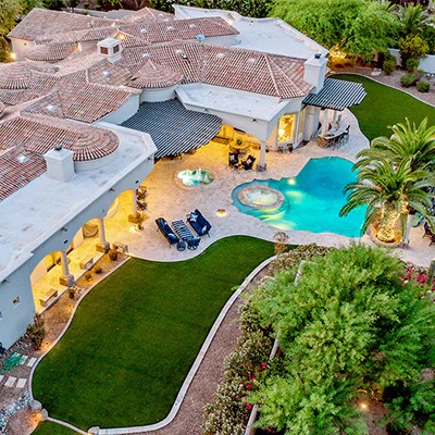 Photo of a luxury home with a pool.