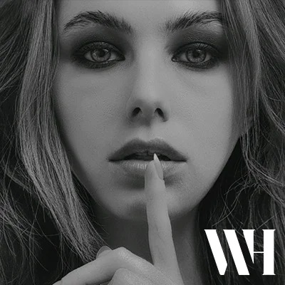 A person gesturing to keep a secret.