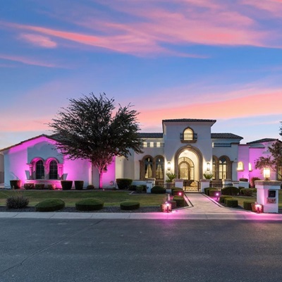 The front a of stunning luxury home at sunset.