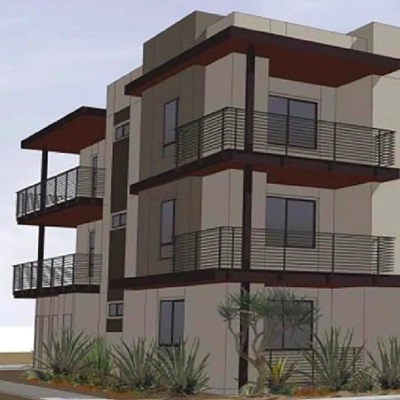 Rendering of Legacy North development showing a modern three-story building with balconies, large windows, and desert landscaping.
