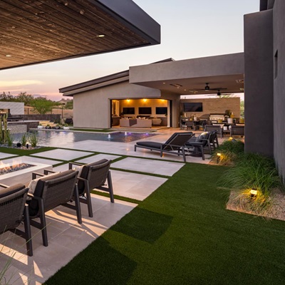Luxurious outdoor space with a fire pit, pool, and covered patio for relaxing.