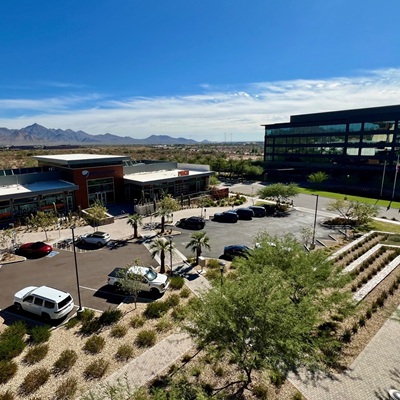 A commercial complex with mountain views, parking spaces, and clean surroundings, illustrating the city’s high-end retail and dining options paired with scenic backdrops.