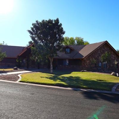 A single story home seen from the street during a blue sky sunny day.