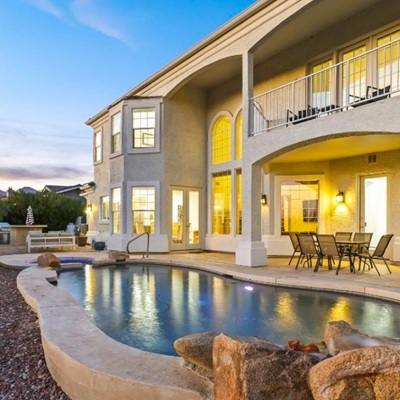 The backyard pool of a luxury home in Fountain Hills at twilight.