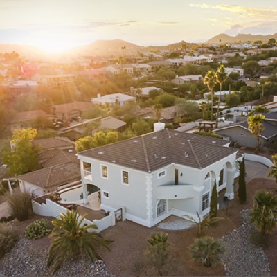 A top-down, angled drone shot of a luxury home and neighborhood in Fountain Hills.
