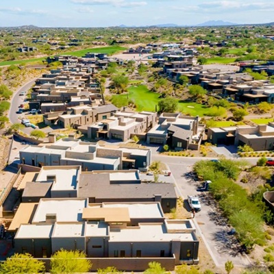 A drone shot overlooking a golf course community in Scottsdale on a sunny day.