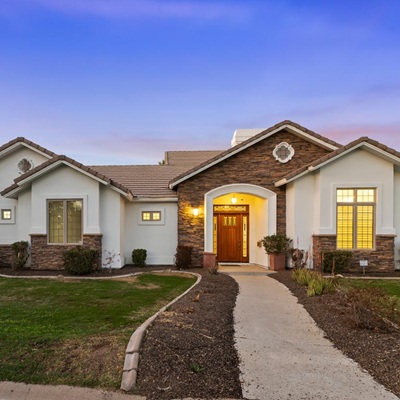 A luxury home in Central Phoenix seen from out front at dusk.