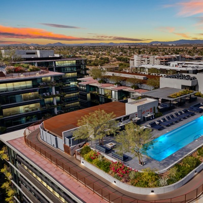 A drone shot looking at the rooftop pool at Optima Kierland at sunset.