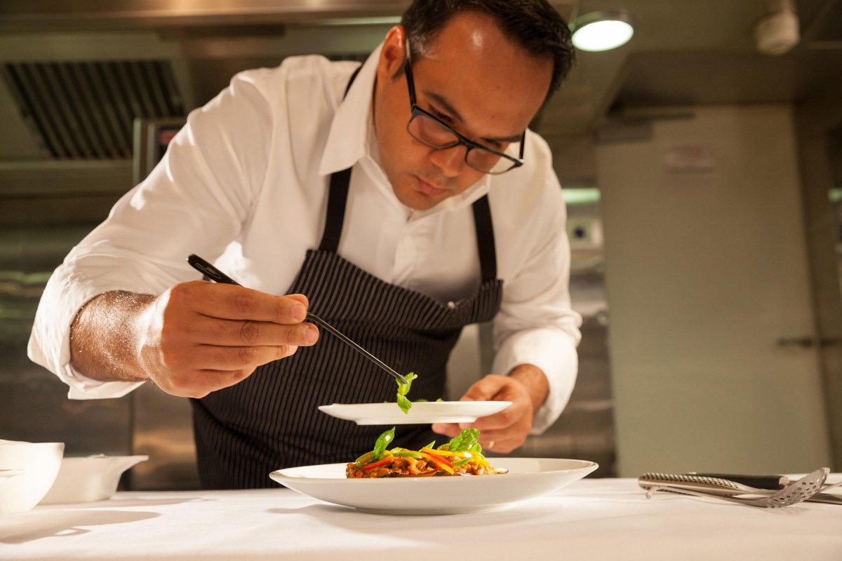 Fine dining chef plating a vegetable dish