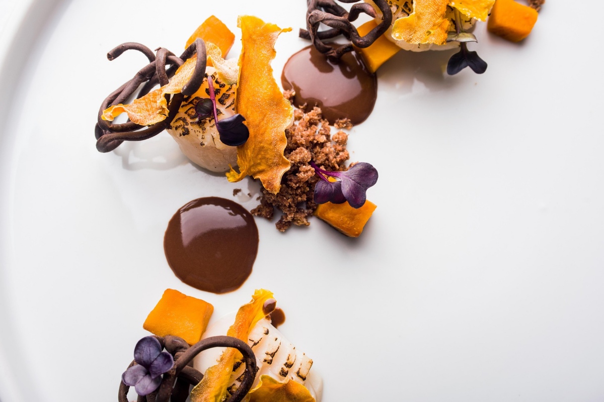 Fine dining dish with dried fruits and chocolate