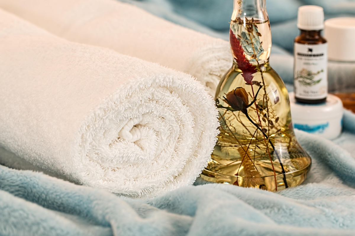 Rolled up towels and massage oils 