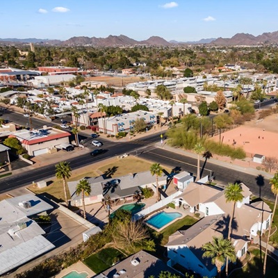 Aerial view of a Phoenix neighborhood with mountains in the distance.