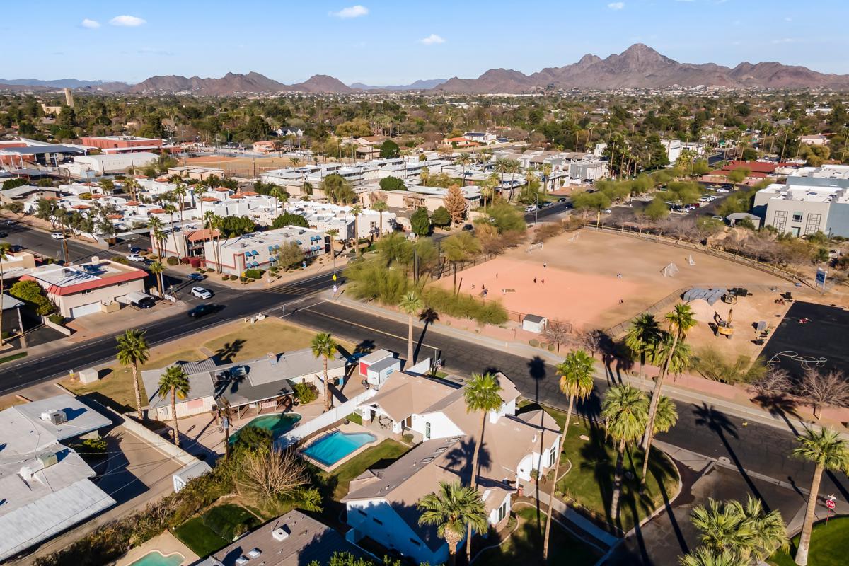 Aerial view of a Phoenix neighborhood with mountains in the distance.