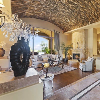 Elegant living room with arched stone ceiling and fireplace.