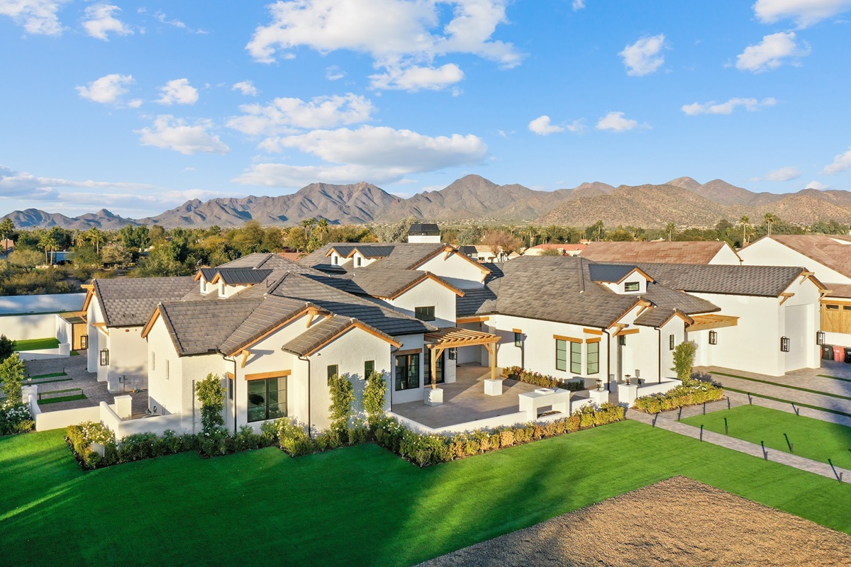 Aerial view of Scottsdale neighborhood with luxury homes and scenic mountains.