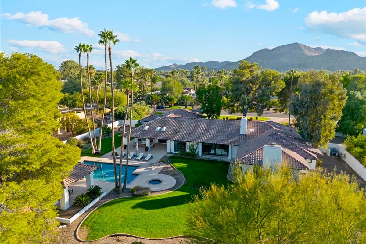 Large Paradise Valley home with beautiful green lawn and a pool