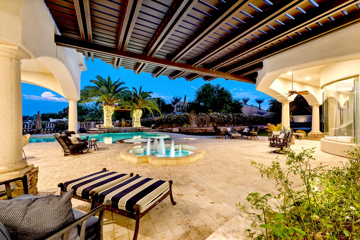Luxury backyard with a pool and pillars