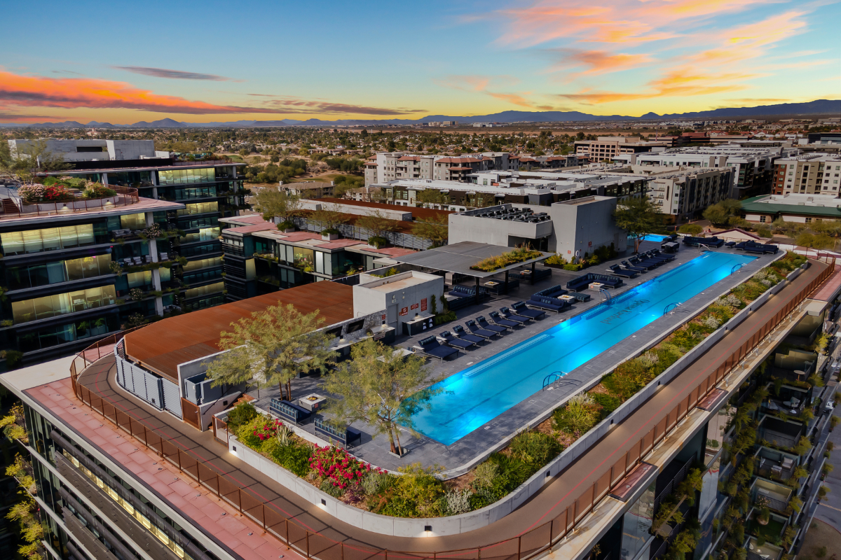 Luxury rooftop pool overlooking downtown Scottsdale at sunset.