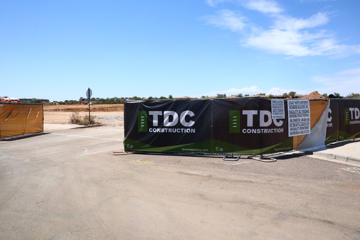 Construction barrier at Legacy North Apartments site by TDC Construction.